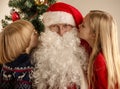Children whispering to Santa Claus