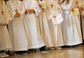 Children with white tunic during the religious rite of the First