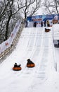 Children in winter ride down the hill