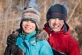 Children in winterwear laughing while playing in snowdrift Royalty Free Stock Photo