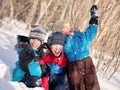 Children in winterwear laughing while playing in snowdrift