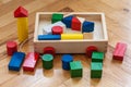 Children wooden trolley with colorful wooden cubes, cylinders an Royalty Free Stock Photo