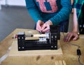 Children work in the training center on wood processing machines.