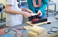 Children work in the training center on wood processing machines. Education in Fablab.