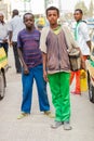 Children working as shoe shine boys on the street, looking straight at the camera