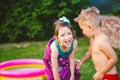 Children wrapped in a beach towel during summer vacation. Wet kids on summer swimming pool with towel. babies having happy time on Royalty Free Stock Photo