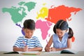 Composite image of children writing on books at table