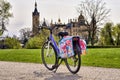 Children's bicycle with saddlebags in the park, with Schwerin Castle in the background