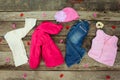 Children's clothing and accessories: jeans, jacket, hat, hair clips and warm vest Royalty Free Stock Photo