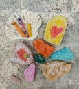 Children& x27;s favorite pastime at sea, painting and drawings on sea stones with crayons, pastels, watercolors