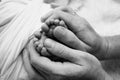 Children& x27;s foot in the hands of mother, father, parents. Feet of a tiny newborn. Royalty Free Stock Photo