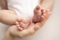 Children& x27;s foot in the hands of mother, father, parents. Feet of a tiny newborn Royalty Free Stock Photo