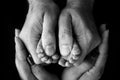 Children& x27;s foot in the hands of mother, father, parents. Feet of a tiny newborn. Royalty Free Stock Photo