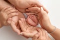 Children& x27;s foot in the hands of mother, father, parents. Feet of a tiny newborn Royalty Free Stock Photo