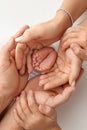 Children& x27;s foot in the hands of mother, father, parents. Feet of a tiny newborn Royalty Free Stock Photo