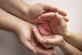 Children& x27;s foot in the hands of mother, father, parents. Feet of a tiny newborn close up. Little baby legs. Royalty Free Stock Photo