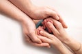 Children& x27;s foot in the hands of mother, father, parents. Feet of a tiny newborn. Royalty Free Stock Photo