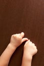 children& x27;s hand on the wooden surface of the table, the development of fine motor skills Royalty Free Stock Photo