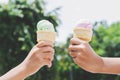 children& x27;s hands holding ice cream cone on summer light nature b