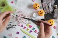 Childrens hands paint on the bandage with paint. Paper, bandage, plasticine with paints on a wooden table. Halloween Royalty Free Stock Photo