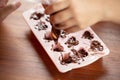 Children& x27;s hands squeeze using pastry bag filling hot melt chocolate into silicone mold.  Selective focus Royalty Free Stock Photo