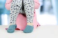 Children's legs hanging down from a chamber-pot on a blue background Royalty Free Stock Photo