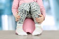 Children's legs hanging down from a chamber-pot on a blue background Royalty Free Stock Photo