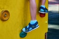 children& x27;s playground in a public park, kid& x27;s entertainment and recreation, mountaineering training, with kid& x27;s leg Royalty Free Stock Photo