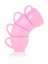 Children's small pink mugs stand on top of each other on a white background. Toy set made of plastic. The concept of a Royalty Free Stock Photo