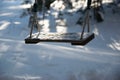Children's Swing in Winter Covered with Snow Royalty Free Stock Photo