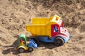 Children's toy cars in the sandbox.Forgotten toys. Royalty Free Stock Photo
