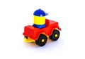 Children's toy, red plastic car with driver on white background. Royalty Free Stock Photo