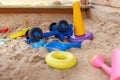 Children's wooden sandbox with various toys for the game. Royalty Free Stock Photo