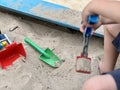 Children& x27;s wooden sandbox with various toys for the game. Summer concept. Royalty Free Stock Photo