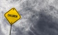 children - yellow sign with cloudy background