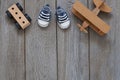 Childrens background, baby toys and shoes, wooden plane and car, layout on wooden background, happy mothers day