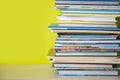 Many childrens books are stacked on top of each other. Green ba Royalty Free Stock Photo