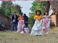 Childrens competiting in sack race. Celebration to welcome Independence day of Indonesia Royalty Free Stock Photo
