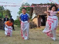 Childrens competiting in sack race. Celebration to welcome Independence day of Indonesia