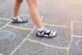 Childrens feet and drawings with chalk on the pavement closeup