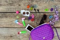 Childrens handbag and accessories: mobile phone, whistle, hair bands, candy, beads, headphones, sunglasses, ball