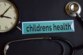 Childrens Health on the print paper with Healthcare Concept Inspiration. alarm clock, Black stethoscope. Royalty Free Stock Photo
