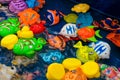 Childrens plastic colorful fish toys in the pool for playing in the fishing