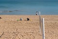 Childrens play in sand of the beach near of sea