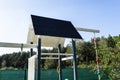 A childrens playground made of wood and painted white and navy blue, visible roof covered with felt.