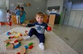 Childrens playing with their teacher at Kindergarten in classroom