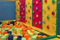 Childrens playroom. Childrens climbing wall with colorful figures. Soft room for games