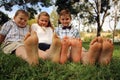 Childrens with their feet toether in the grass Royalty Free Stock Photo