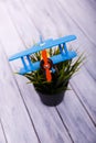 Childrens toy airplane on the flowerpot on the wooden background. Royalty Free Stock Photo