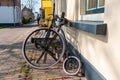 Childrens vintage penny farthing high wheel bicycle outside a dutch small town home on a street